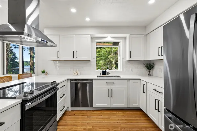 a kitchen with a sink stove and cabinets