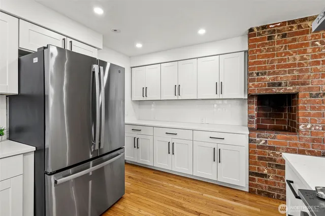 a kitchen with stainless steel appliances a refrigerator sink and cabinets