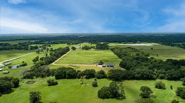 a view of a green field with an ocean