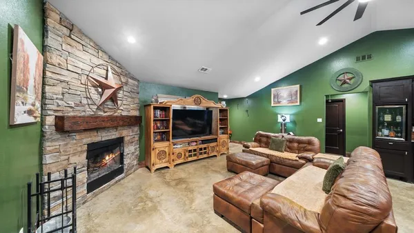 a living room with a bookshelf and a fireplace