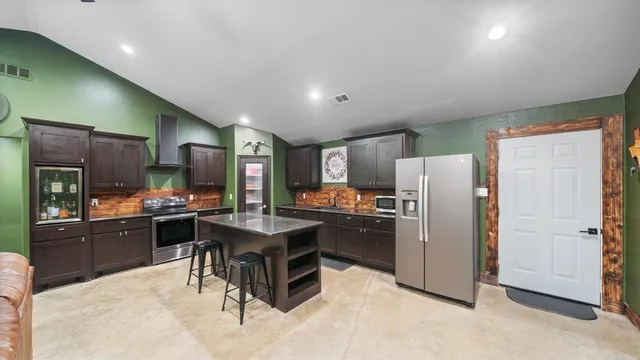 a kitchen with stainless steel appliances a sink stove and refrigerator