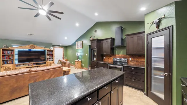 a kitchen with stainless steel appliances granite countertop a stove and a refrigerator