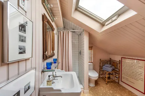 a bathroom with a sink toilet and a mirror
