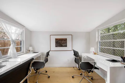 a workspace with furniture and a window