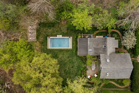an aerial view of a house with a yard