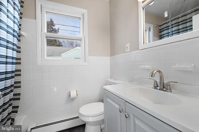 a bathroom with a sink toilet and a mirror