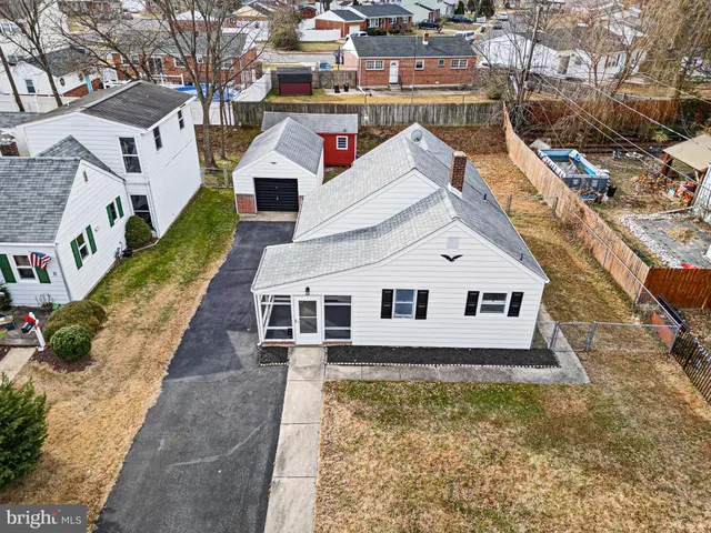 an aerial view of residential houses with yard