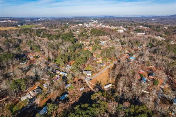 a view of a swimming pool with a patio and a yard
