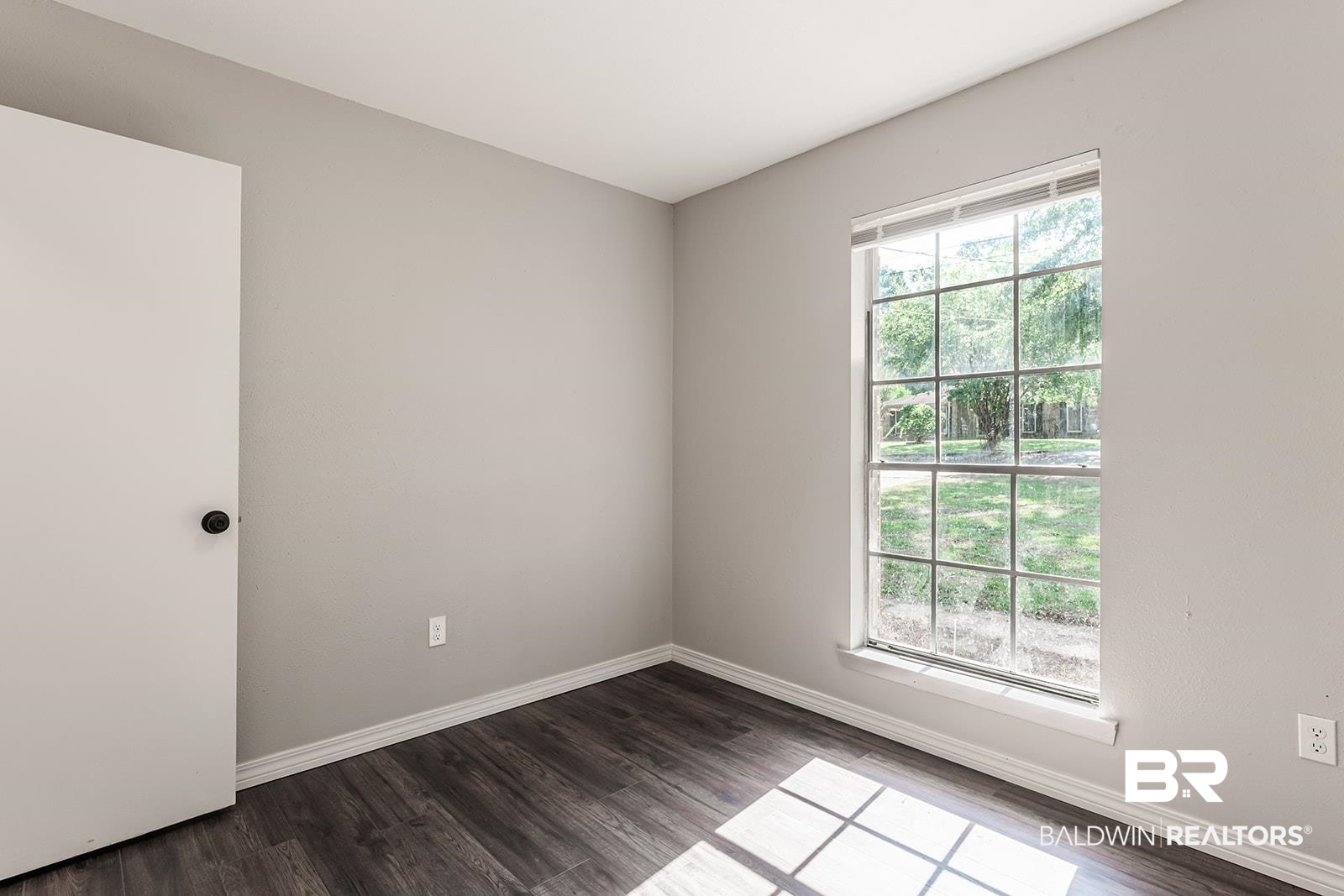 4626 Gold Drive Mobile, AL 36619 - Photo 32 of 48 Empty room featuring a wealth of natural light and wood-type flooring
