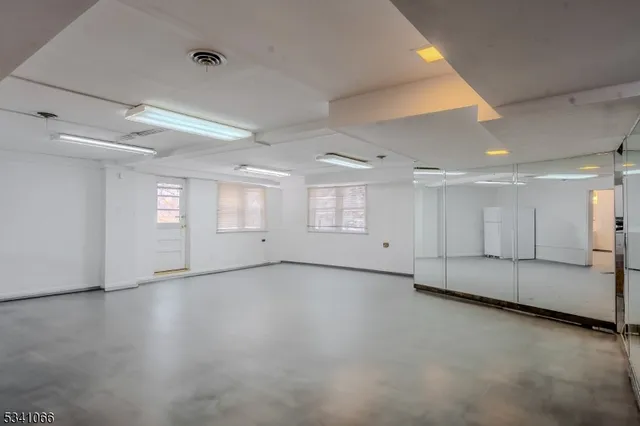 an empty room with a empty space and windows