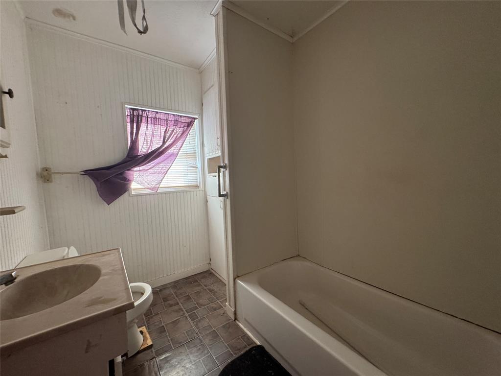 610 5th Street Hawley, TX 79525 - Photo 12 of 19 a bathroom with a sink and toilet