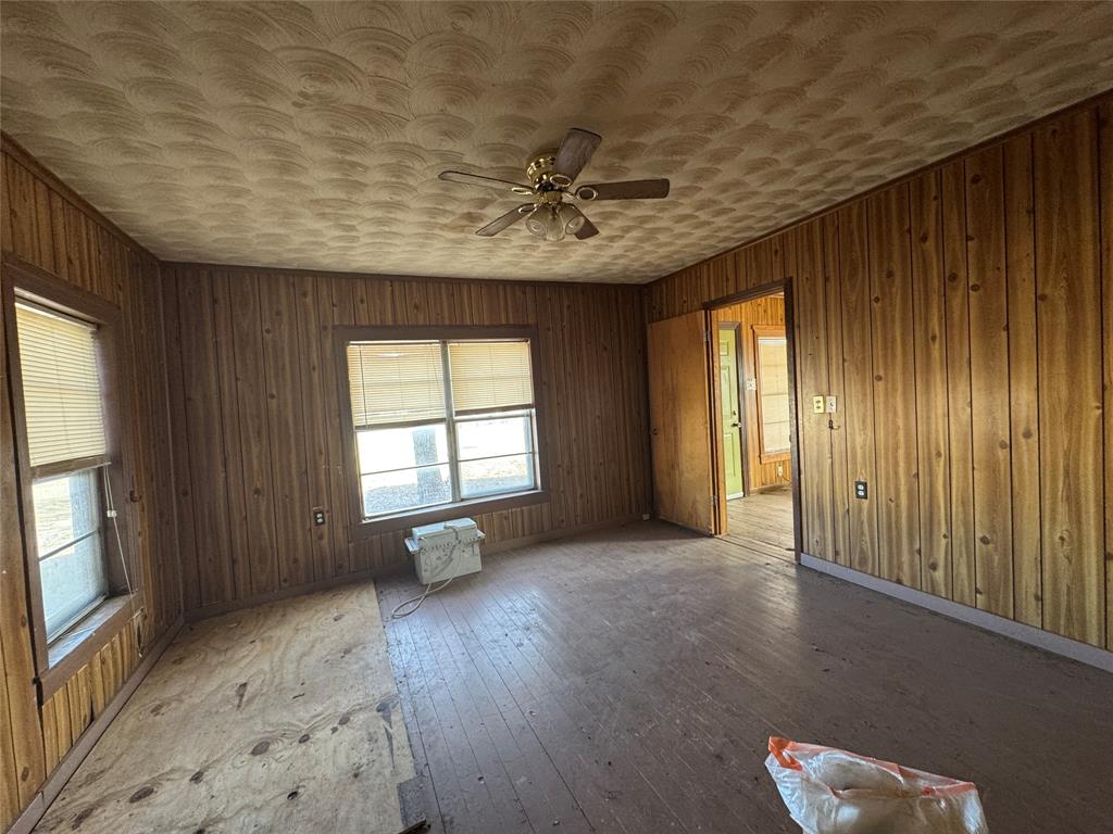 610 5th Street Hawley, TX 79525 - Photo 5 of 19 wooden floor in an empty room with a window