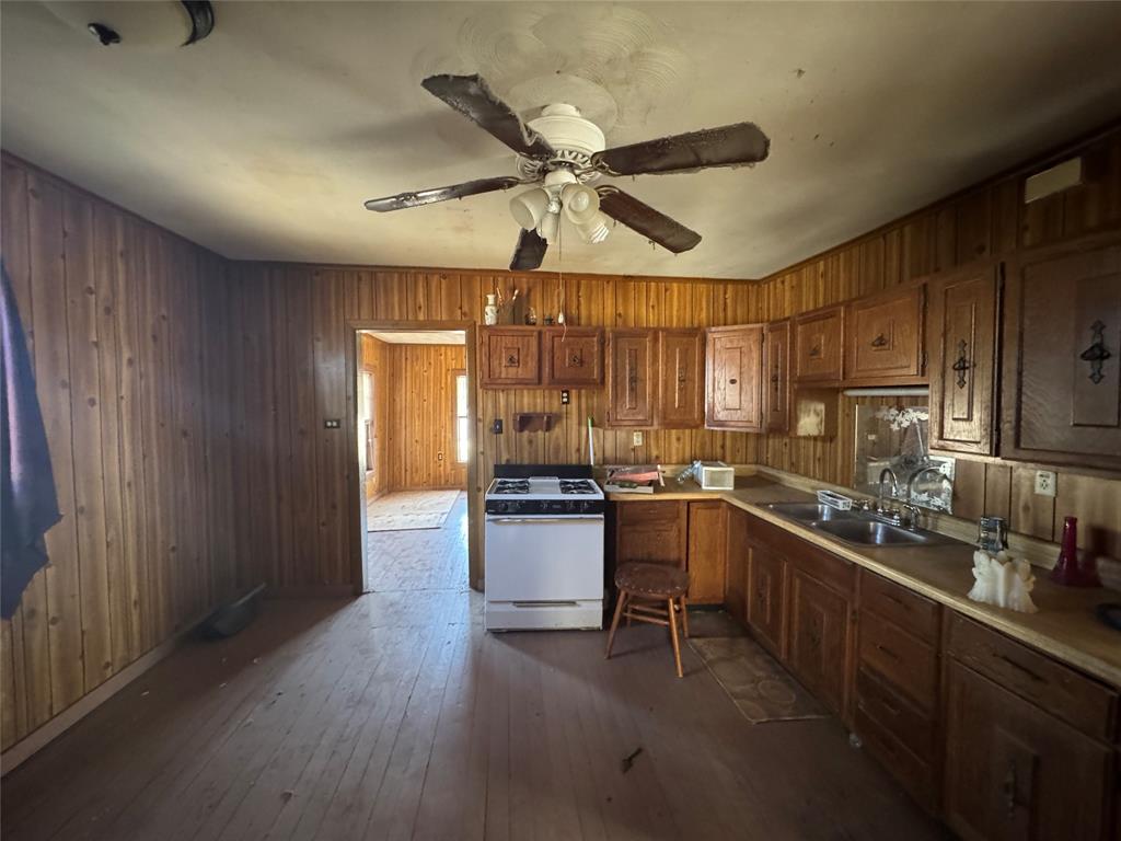 610 5th Street Hawley, TX 79525 - Photo 6 of 19 a kitchen with a sink stainless steel appliances and cabinets