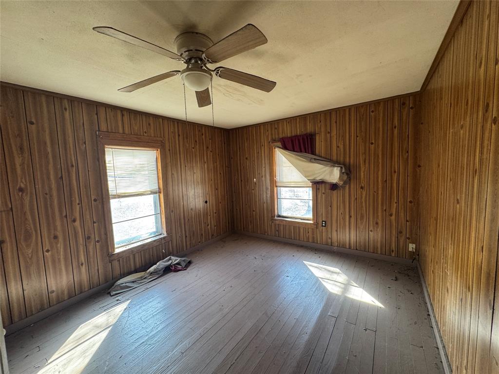 610 5th Street Hawley, TX 79525 - Photo 10 of 19 an empty room with wooden floor and windows