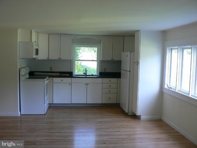 7423 Station Road Newcomb, MD 21653 - Photo 11 of 17 a kitchen with a sink a window and appliances