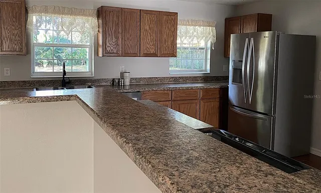 a kitchen with granite countertop a sink and cabinets