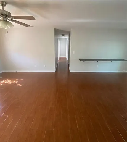 a view of wooden floor and windows in a room