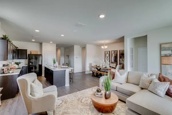 a living room with furniture kitchen and a table