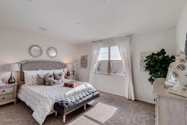 a bedroom with a bed and window