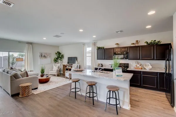 a living room with lots of furniture and kitchen view