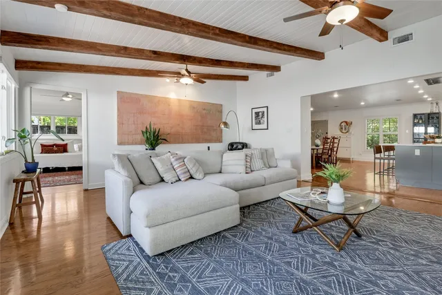 a living room with furniture and a glass table
