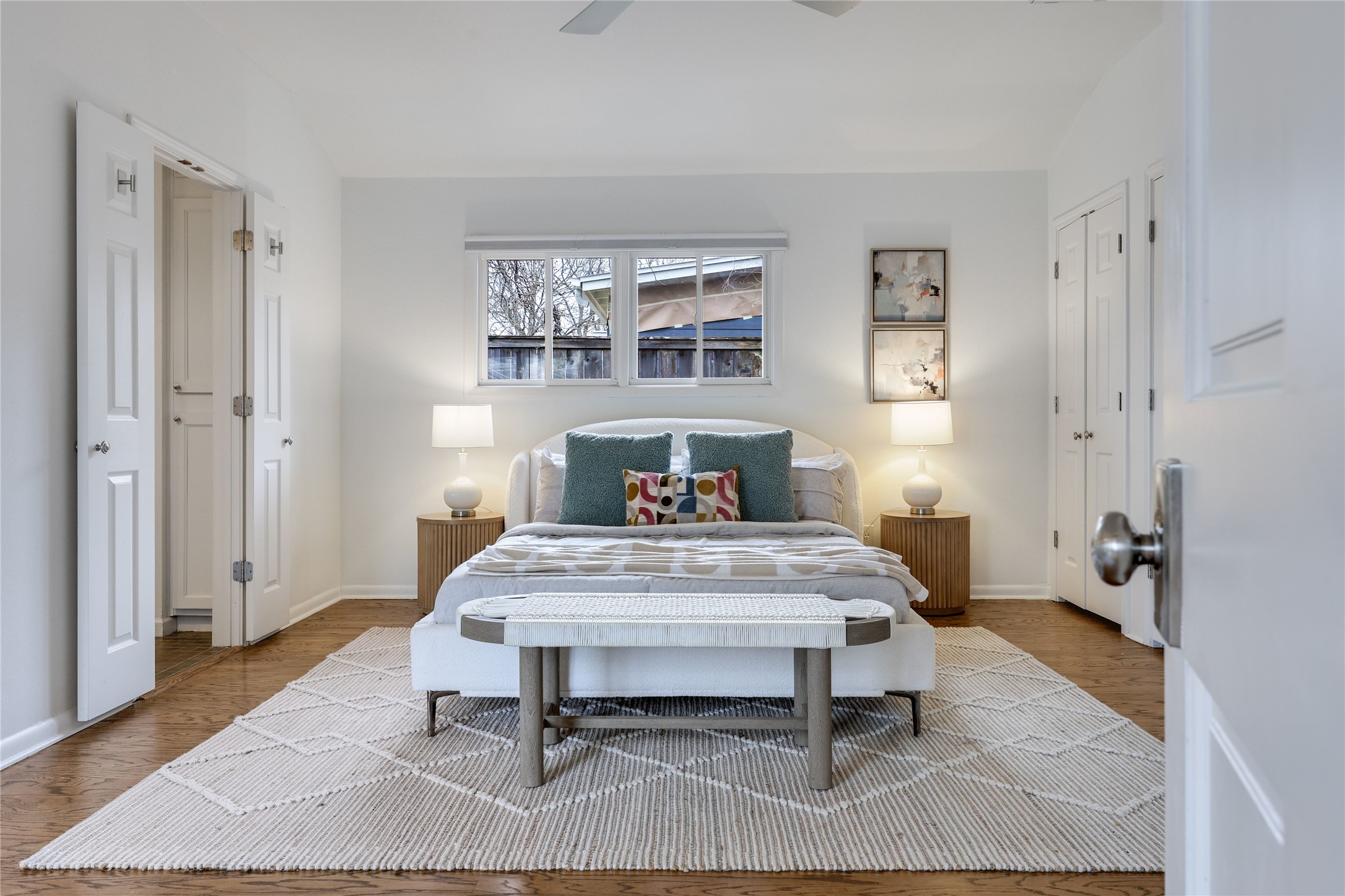 2908 Perry Lane Austin, TX 78731 - Photo 17 of 37 a bedroom with a bed and wooden floor