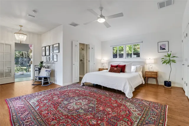 a bedroom with bed and a chandelier