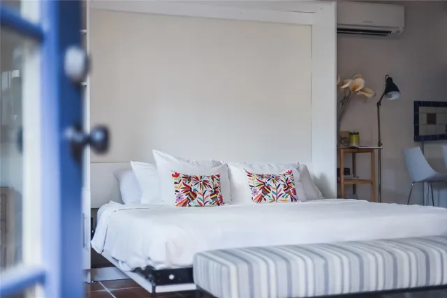 a bedroom with a bed and a night stand