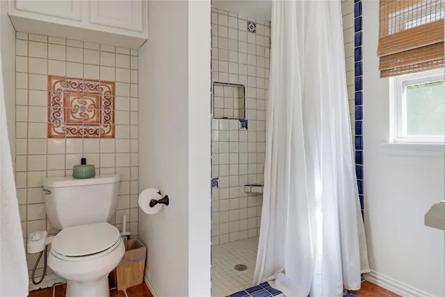 a white toilet sitting next to a bathroom sink
