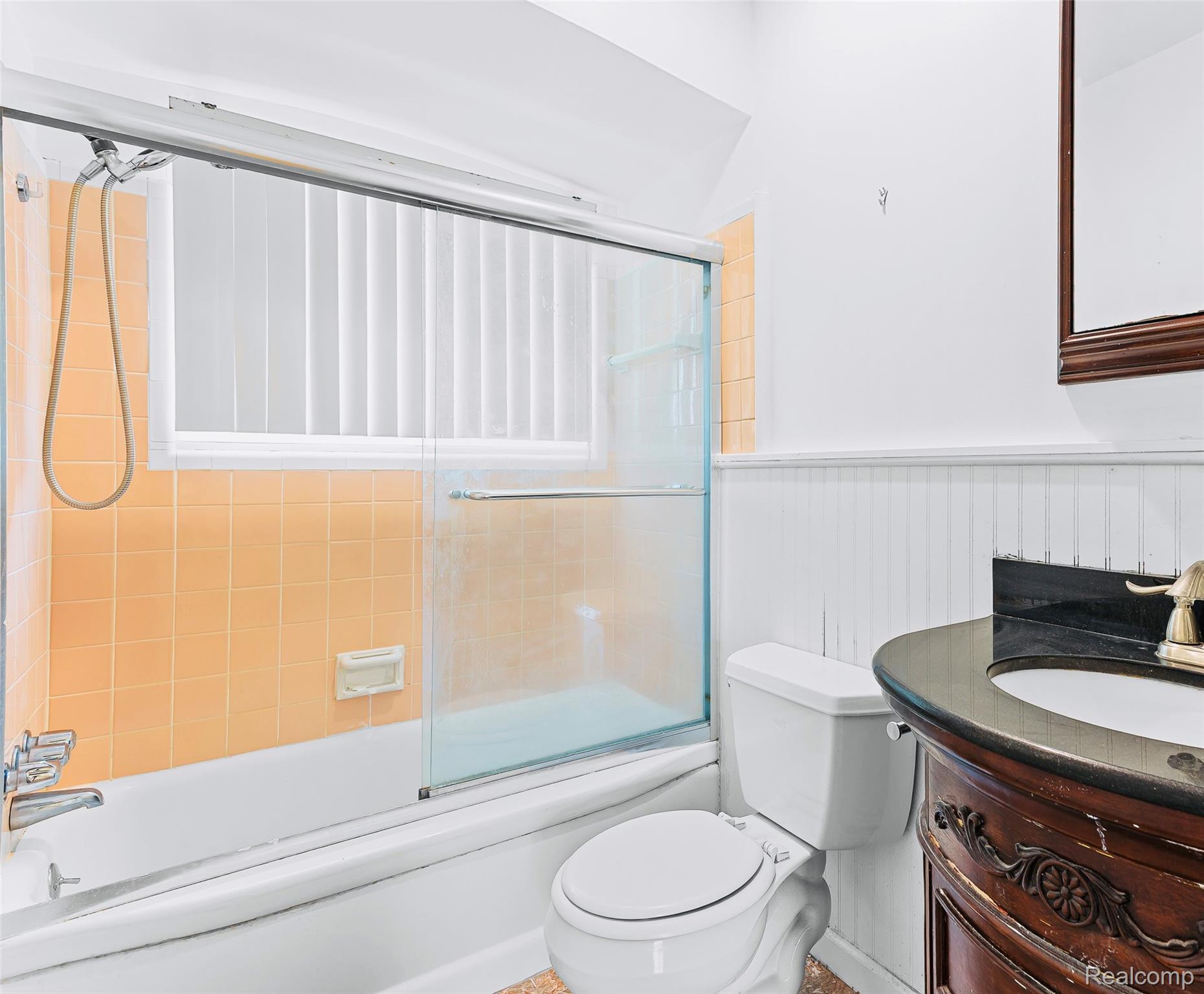 2345 Middlefield Road Trenton, MI 48183 - Photo 23 of 42 Bathroom featuring a white tub, sliding glass shower doors, and orange wall tile