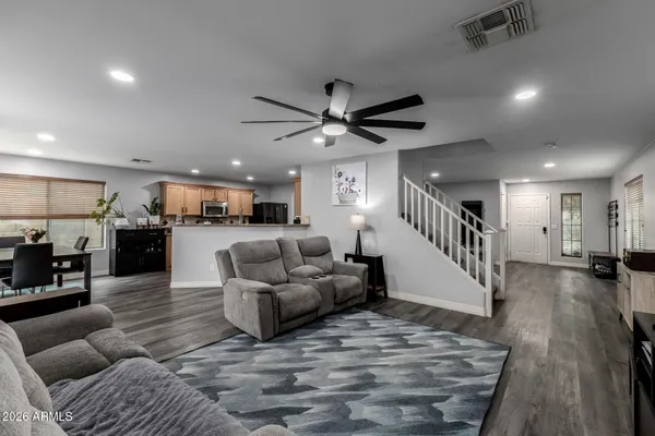 a living room with furniture and kitchen view