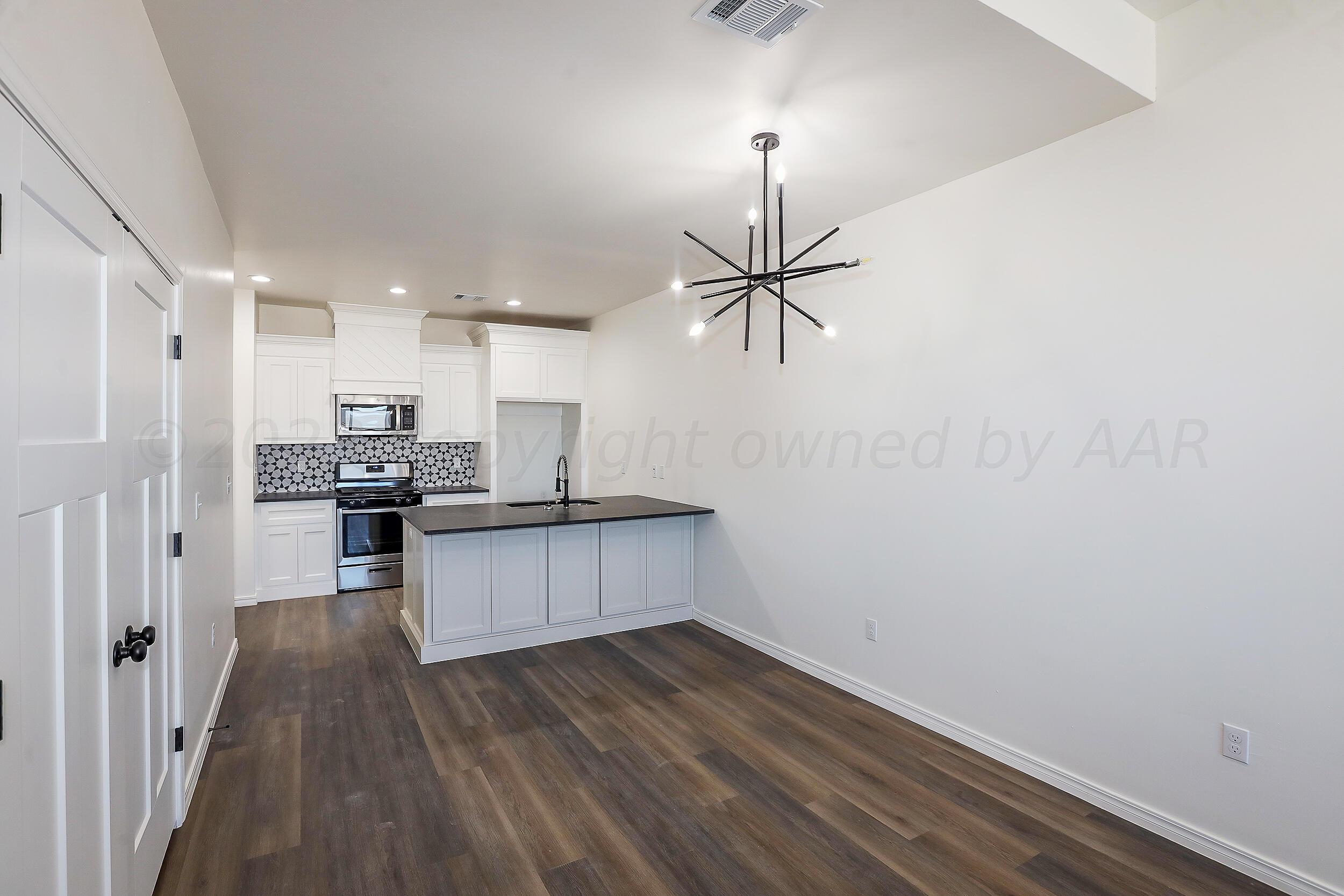 13771 Periwinkle Drive Amarillo, TX 79119 - Photo 11 of 23 a kitchen with a refrigerator and white cabinets