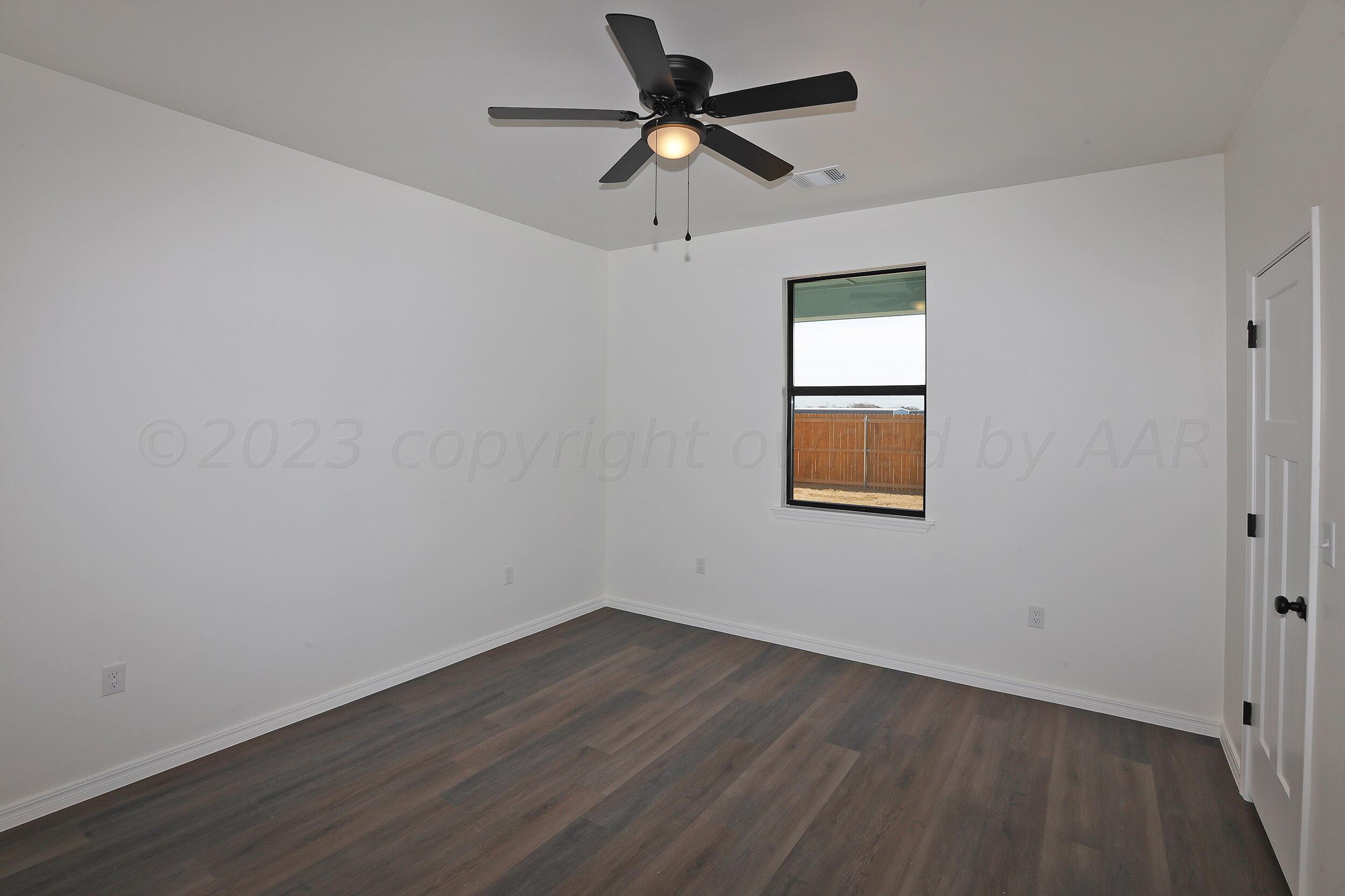 13771 Periwinkle Drive Amarillo, TX 79119 - Photo 12 of 23 a room with a window and a ceiling fan
