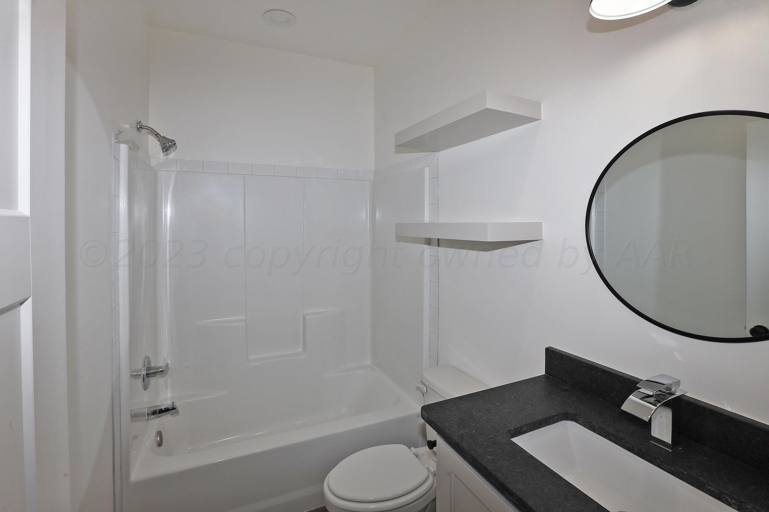 13771 Periwinkle Drive Amarillo, TX 79119 - Photo 13 of 23 a bathroom with a sink toilet and a mirror