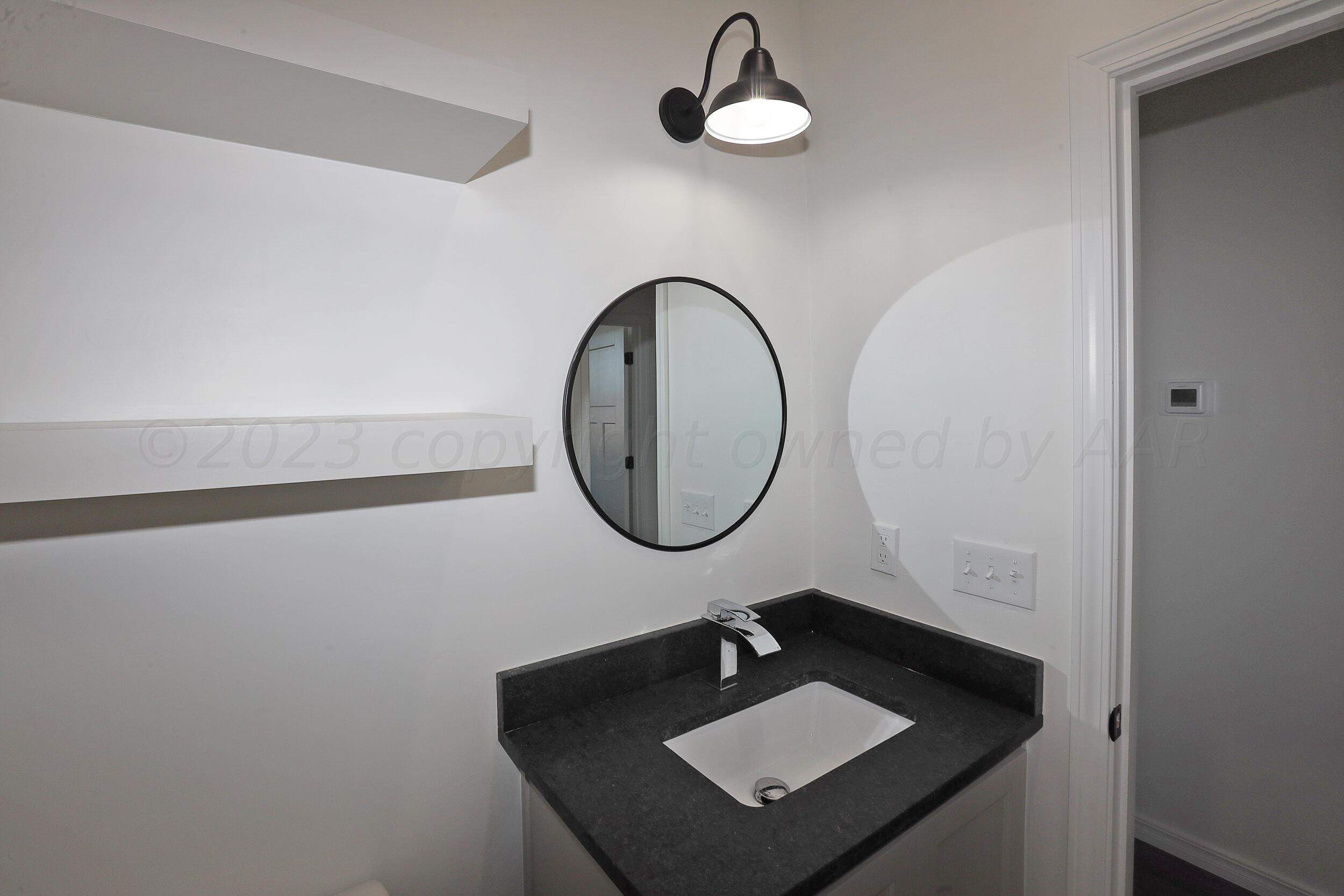 13771 Periwinkle Drive Amarillo, TX 79119 - Photo 17 of 23 a bathroom with a sink and a mirror
