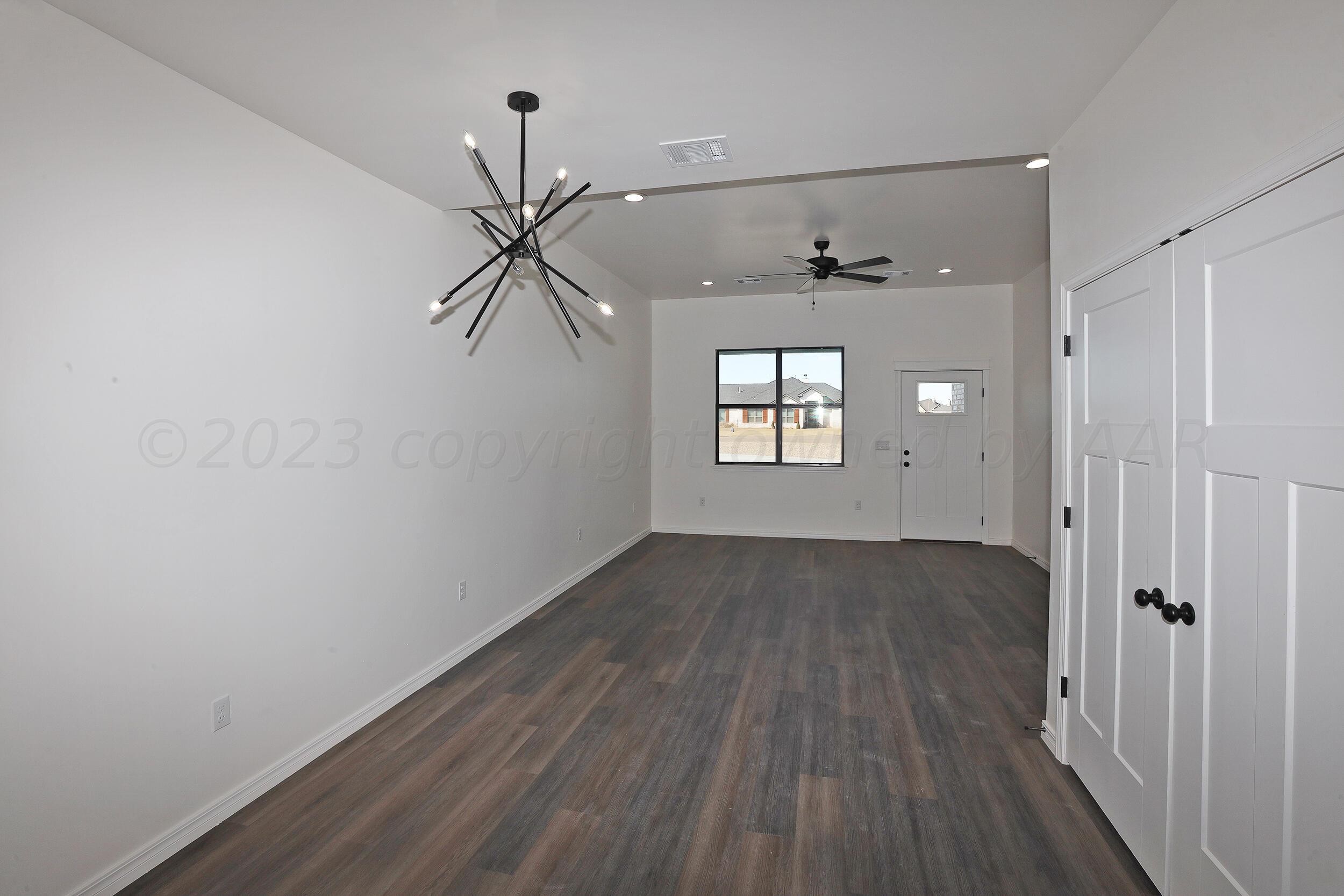 13771 Periwinkle Drive Amarillo, TX 79119 - Photo 5 of 23 a view of empty room with wooden floor and fan