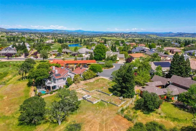 an aerial view of residential houses with outdoor space and street view