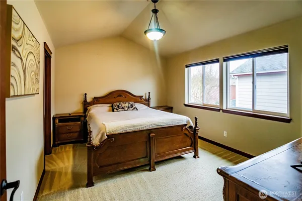 a bedroom with a bed and windows