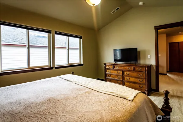 a bedroom with a bed and a flat screen tv