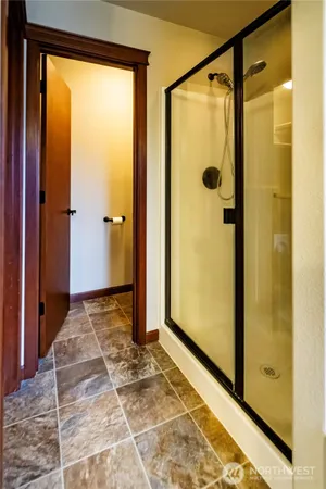 a view of a bathroom with a shower and a glass door