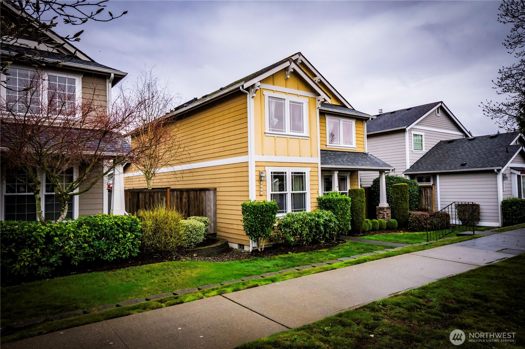 4646 Rochelle Street Southeast Lacey, WA 98503 - Photo 2 of 31 a front view of a house with a yard and potted plants