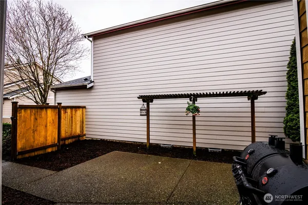 a view of a house with a large window and a yard