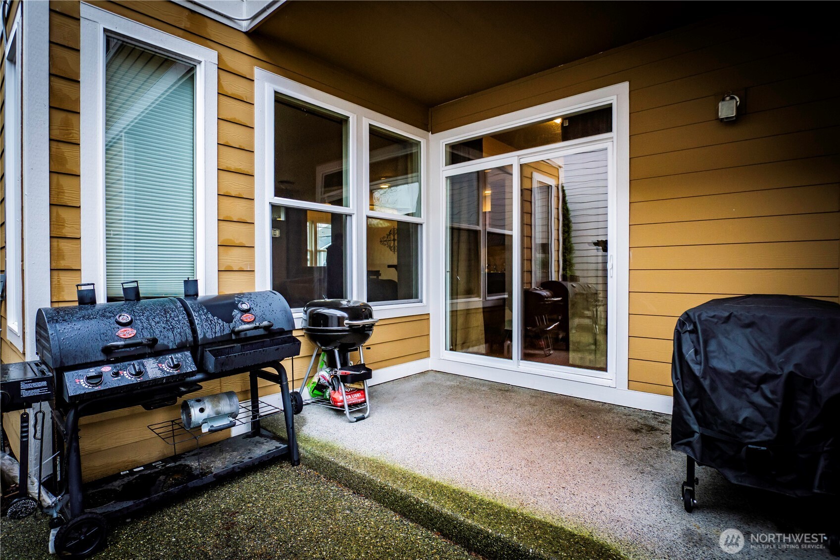 4646 Rochelle Street Southeast Lacey, WA 98503 - Photo 25 of 31 a view of a house with a large window and a yard