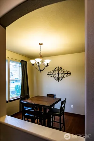 a room with a table chairs and wooden floor