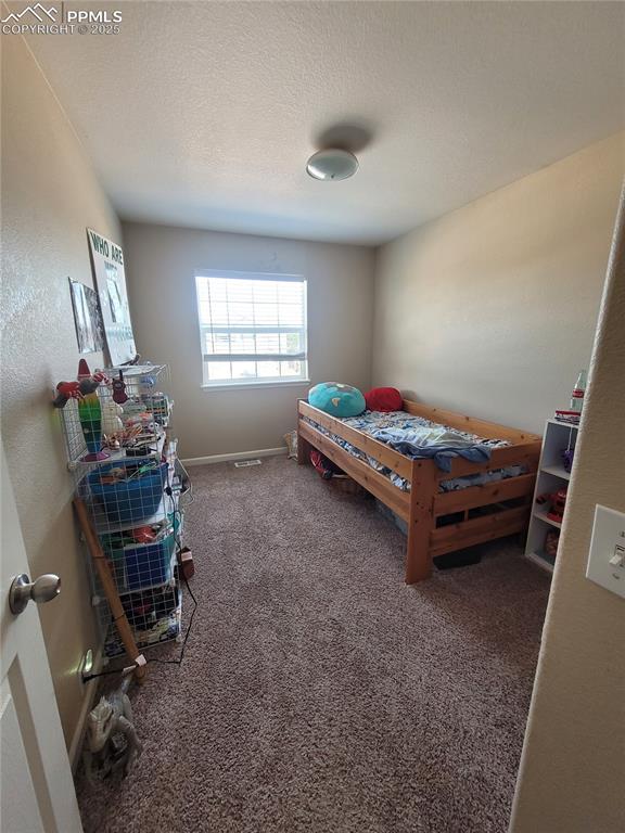 8975 Kingston Heath Road Peyton, CO 80831 - Photo 12 of 18 a bedroom with furniture and a window
