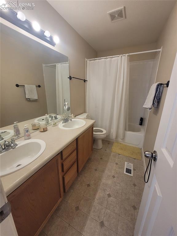 8975 Kingston Heath Road Peyton, CO 80831 - Photo 17 of 18 a bathroom with a double vanity sink and a mirror