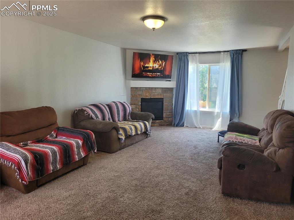 8975 Kingston Heath Road Peyton, CO 80831 - Photo 2 of 18 a spacious bedroom with two beds and a fireplace