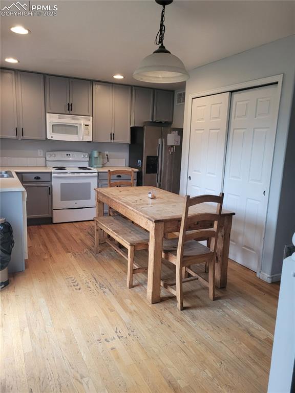 8975 Kingston Heath Road Peyton, CO 80831 - Photo 3 of 18 a kitchen with stainless steel appliances a stove a sink island and a refrigerator