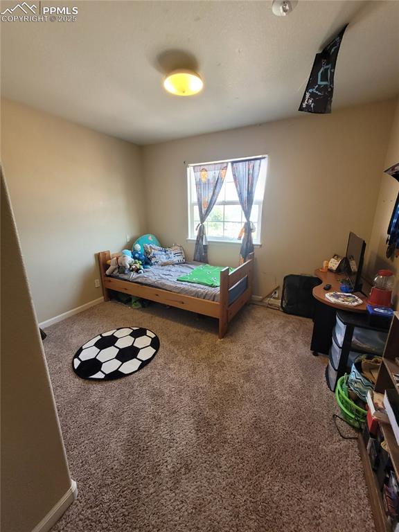 8975 Kingston Heath Road Peyton, CO 80831 - Photo 5 of 18 a living room with furniture and a wooden floor