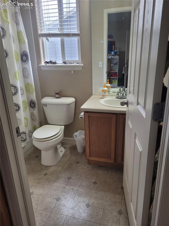 8975 Kingston Heath Road Peyton, CO 80831 - Photo 8 of 18 a bathroom with a sink toilet and mirror